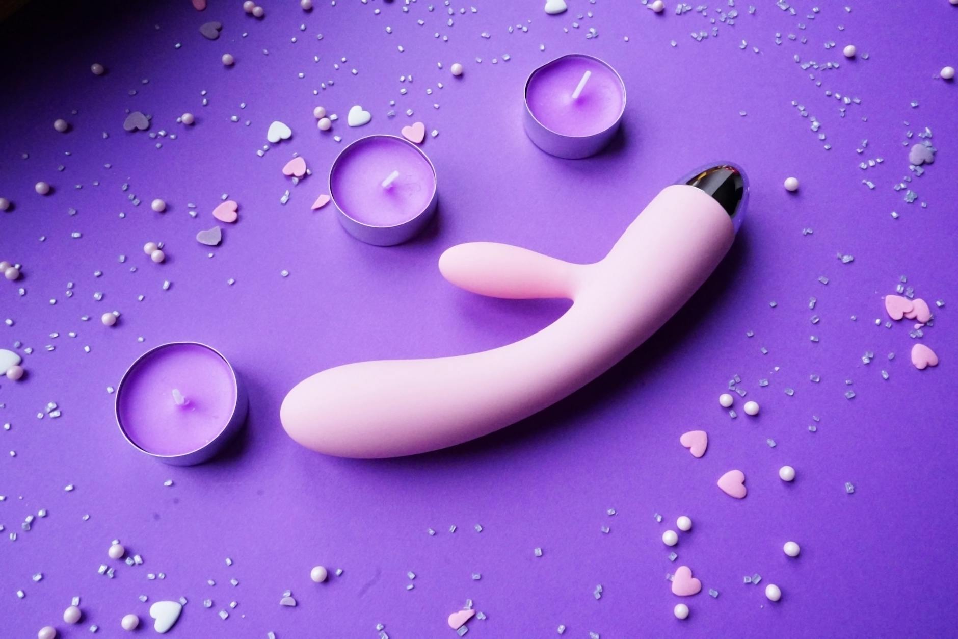 Lemon vibrator displayed with romantic lighting and candles, representing pleasure across the menstrual cycle
