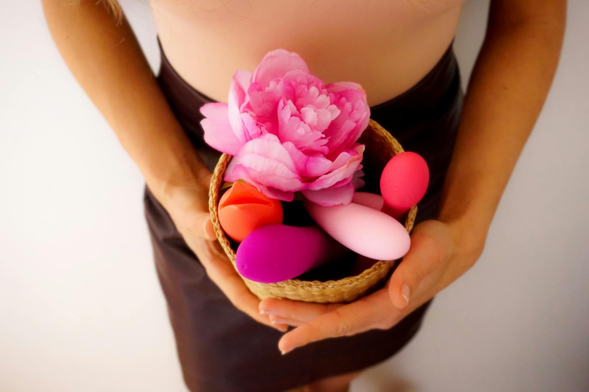 Woman contemplatively holding a silicone vibrator, exploring sensations and reconnection