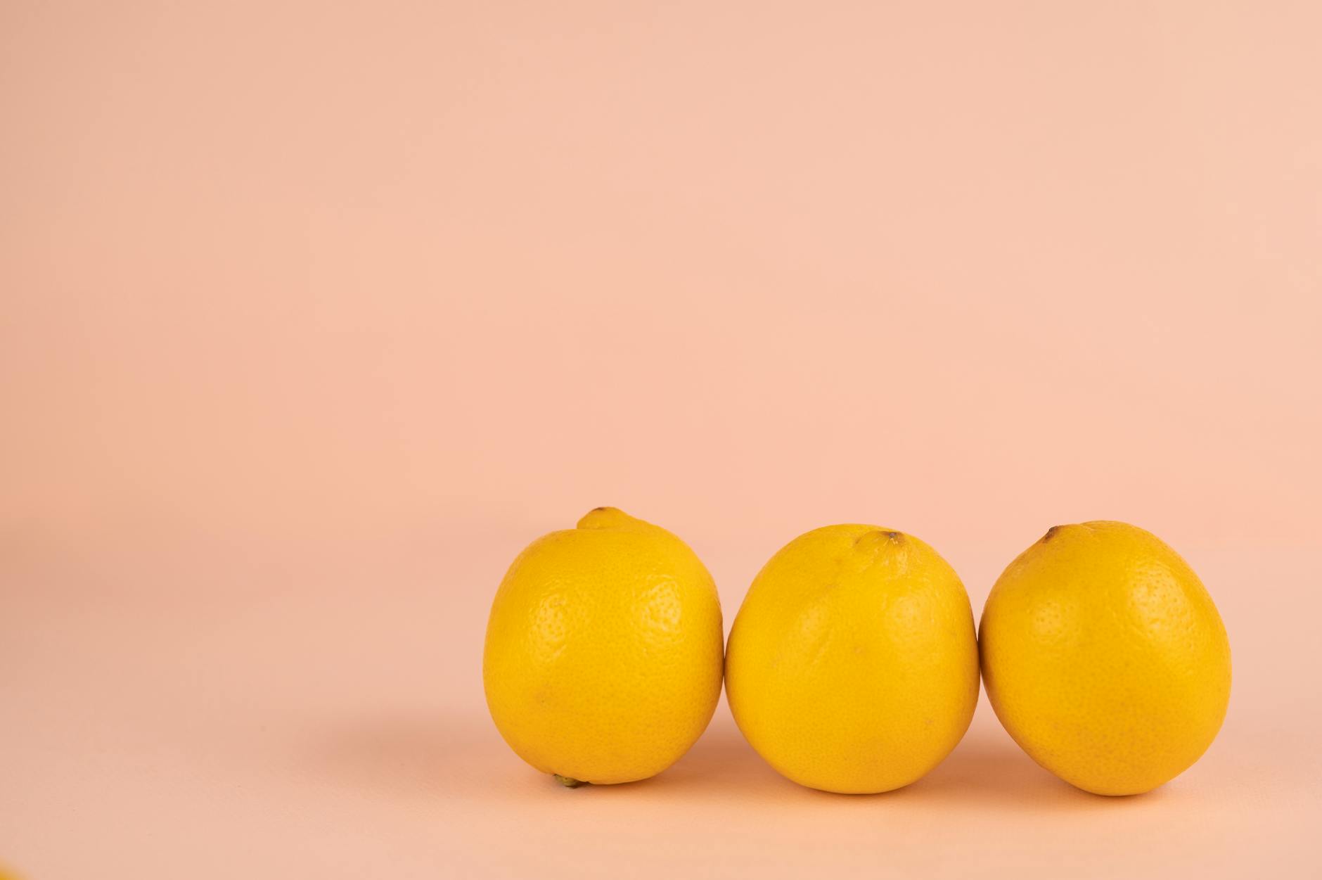 Bright ripe lemons arranged on a soft pastel background, symbolizing renewed sensation and freshness